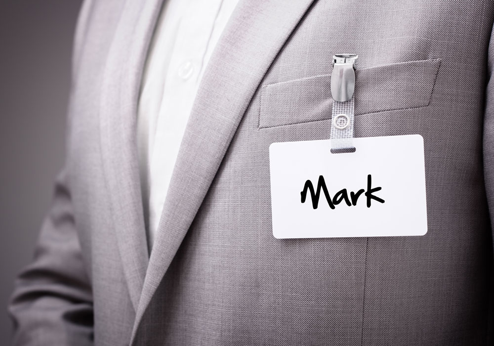 Name tag on grey business suit